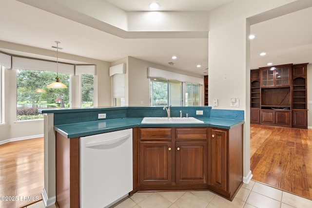 7 Fenwick Dr, Bluffton, SC 29909 - kitchen featuring white dishwasher, a sink, plenty of natural light, brown cabinets, and recessed lighting