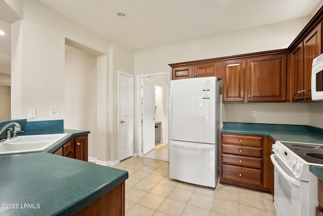 7 Fenwick Dr, Bluffton, SC 29909 - kitchen featuring white appliances, a sink, dark countertops, light tile patterned floors, and recessed lighting