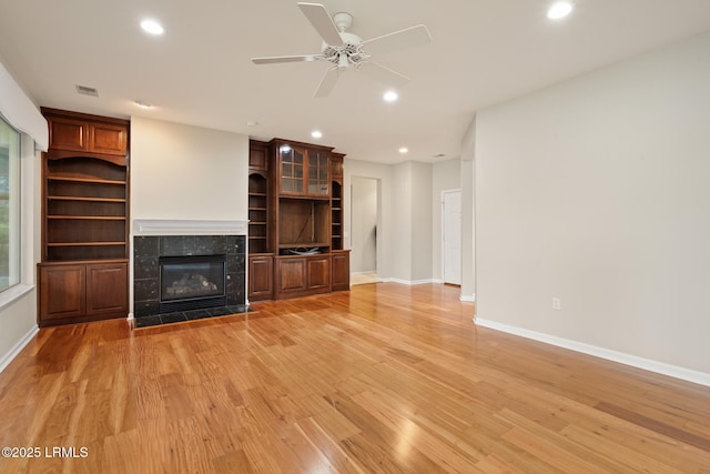 7 Fenwick Dr, Bluffton, SC 29909 - unfurnished living room featuring light wood finished floors, a fireplace, recessed lighting, ceiling fan, and baseboards