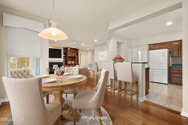 7 Fenwick Dr, Bluffton, SC 29909 - dining space with a ceiling fan, light wood-type flooring, recessed lighting, a fireplace, and baseboards