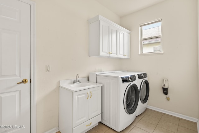 7 Fenwick Dr, Bluffton, SC 29909 - laundry area with washer and dryer, cabinet space, baseboards, and light tile patterned flooring