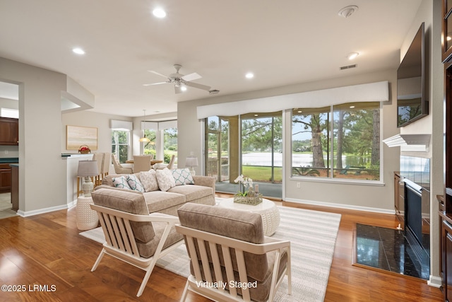 7 Fenwick Dr, Bluffton, SC 29909 - living area featuring baseboards, recessed lighting, ceiling fan, light wood-style flooring, and a fireplace