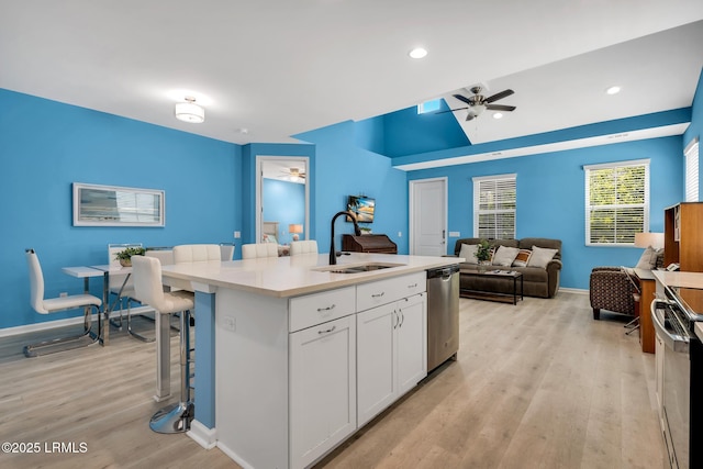 39 Island Breeze Ln Unit 102, Hardeeville, SC 29927 - kitchen featuring a sink, ceiling fan, appliances with stainless steel finishes, open floor plan, and light wood-style flooring