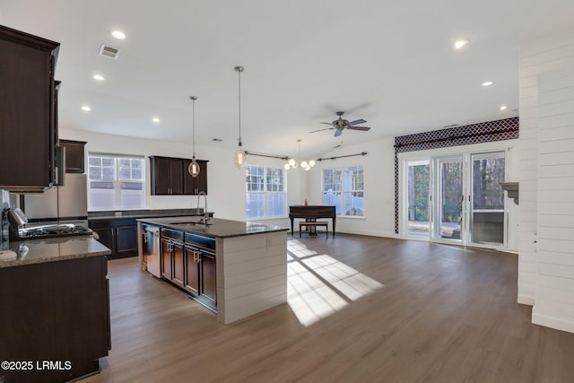 kitchen with dark brown cabinetry, visible vents, ceiling fan, and a sink