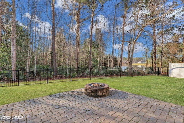 view of patio with a fire pit and fence