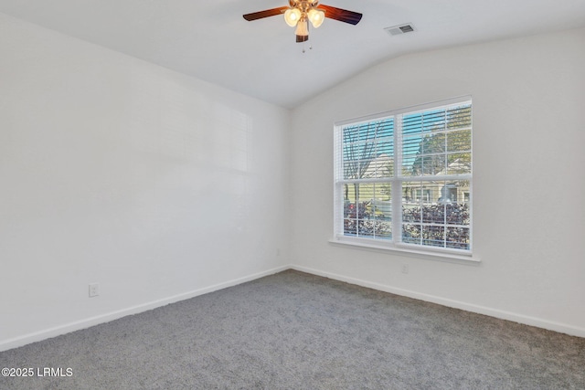 carpeted spare room featuring baseboards, lofted ceiling, visible vents, and ceiling fan