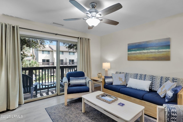 living room featuring ceiling fan and wood-type flooring