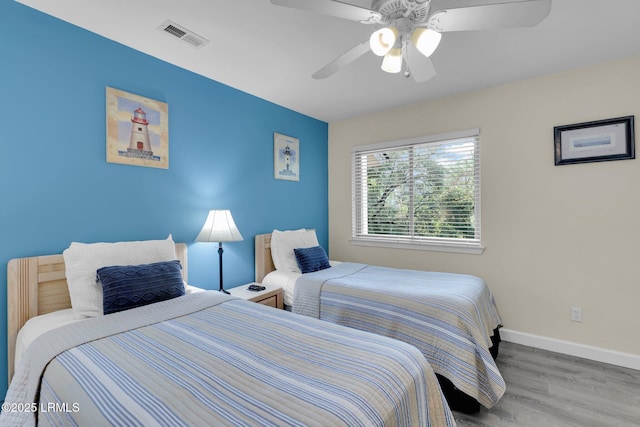 bedroom with ceiling fan and light hardwood / wood-style floors