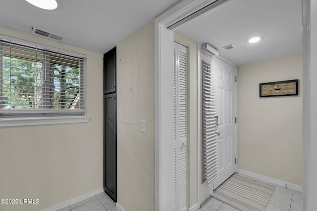 hall featuring light tile patterned floors