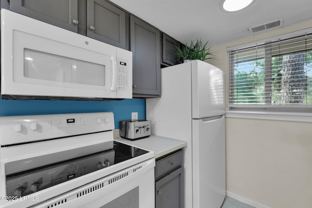 kitchen with white appliances and gray cabinets