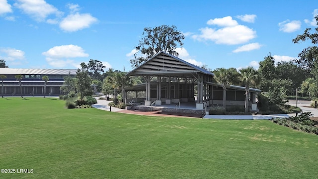 back of house featuring a gazebo and a lawn