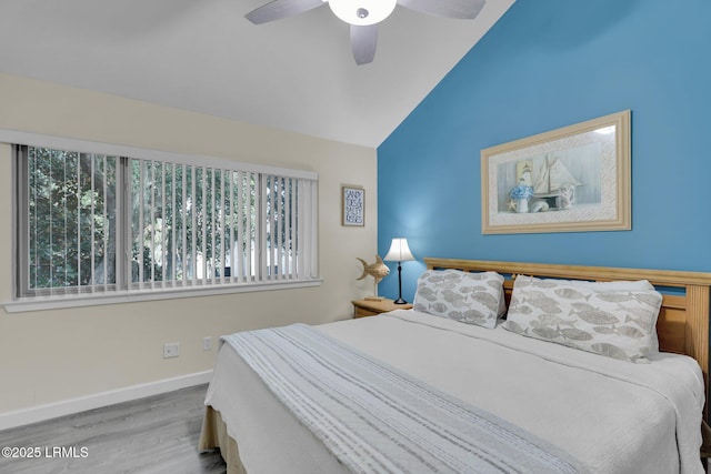 bedroom with ceiling fan, lofted ceiling, and light hardwood / wood-style floors