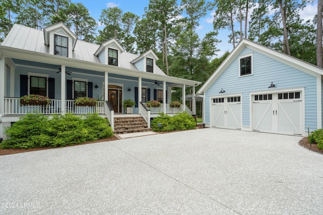 cape cod house featuring an outdoor structure, a garage, a ceiling fan, and covered porch