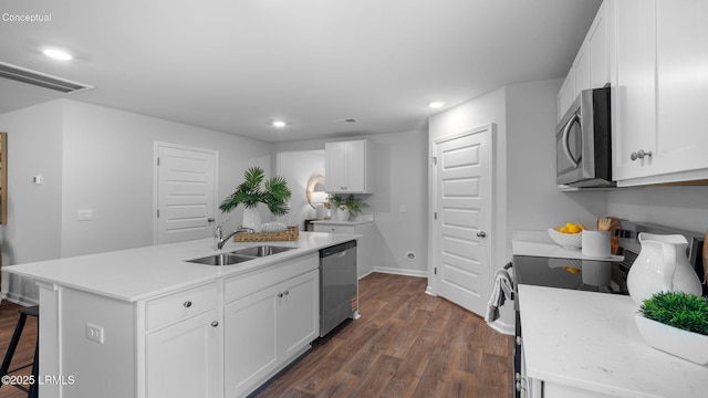 1493 Sanctum St, Ridgeland, SC 29936 - kitchen with stainless steel appliances, a sink, dark wood-style flooring, an island with sink, and recessed lighting