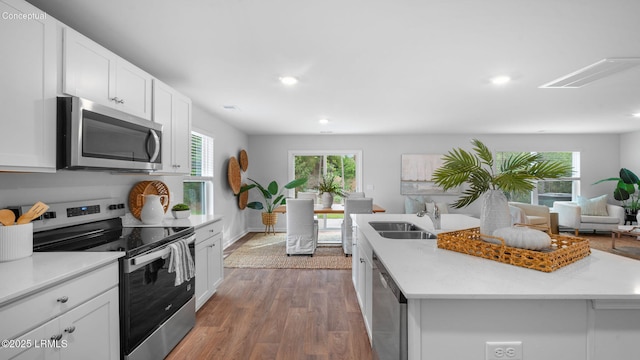 1493 Sanctum St, Ridgeland, SC 29936 - kitchen featuring stainless steel appliances, a sink, a kitchen island with sink, wood finished floors, and light countertops