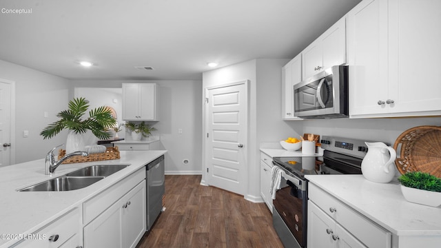 1493 Sanctum St, Ridgeland, SC 29936 - kitchen featuring appliances with stainless steel finishes, a sink, dark wood-type flooring, recessed lighting, and white cabinets