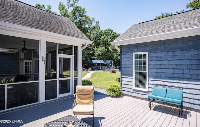 wooden terrace featuring a yard, a sunroom, and ceiling fan