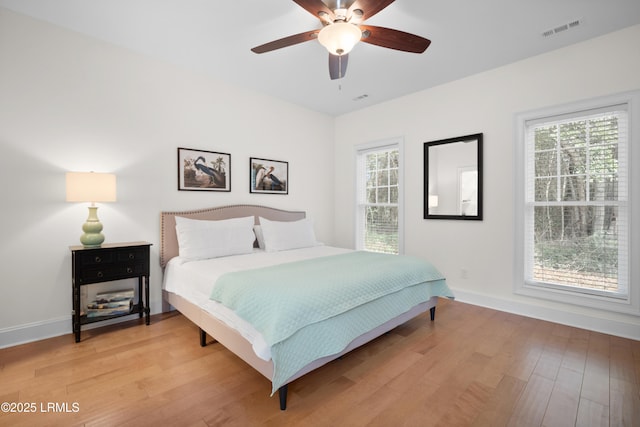 bedroom with ceiling fan and light hardwood / wood-style flooring