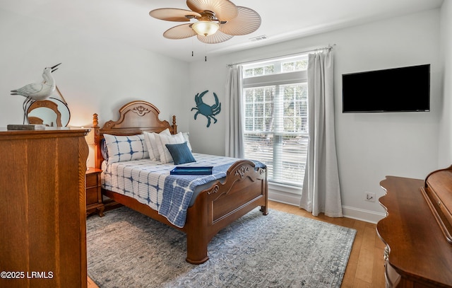 bedroom with wood-type flooring and ceiling fan