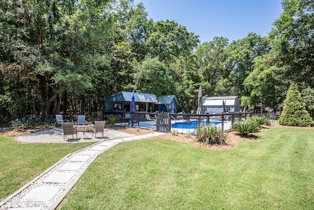 view of yard with an outdoor structure and a patio