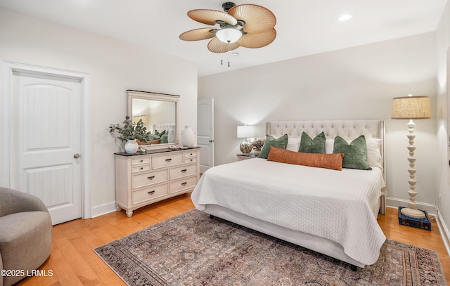 bedroom with light hardwood / wood-style floors and ceiling fan