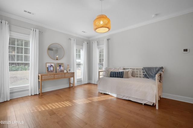 bedroom featuring hardwood / wood-style flooring and ornamental molding