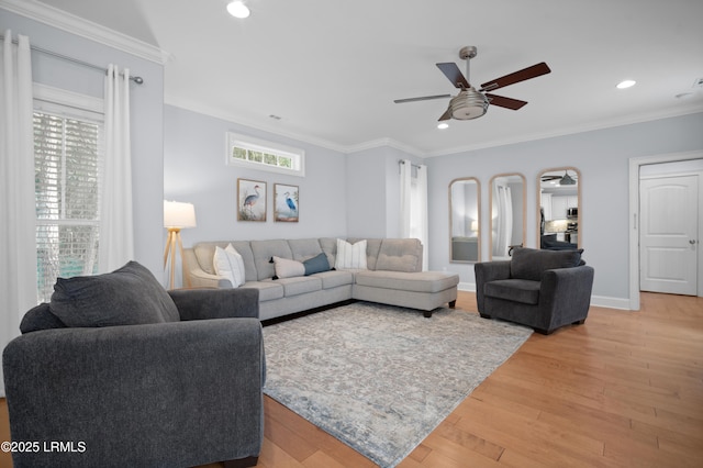 living room with crown molding, ceiling fan, and hardwood / wood-style floors