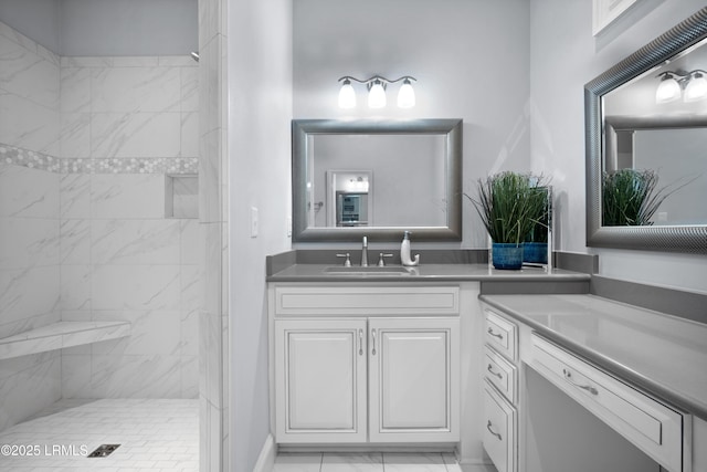 bathroom featuring vanity and a tile shower