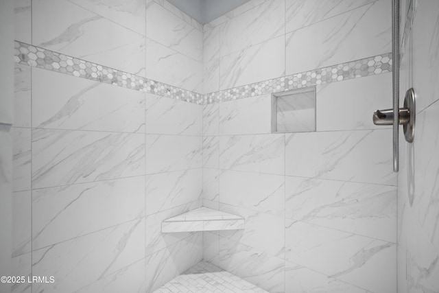 bathroom with a tile shower