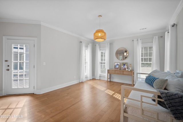 living room featuring crown molding and light hardwood / wood-style flooring