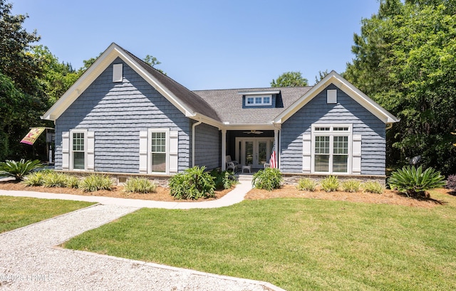 view of front facade featuring french doors, ceiling fan, and a front lawn