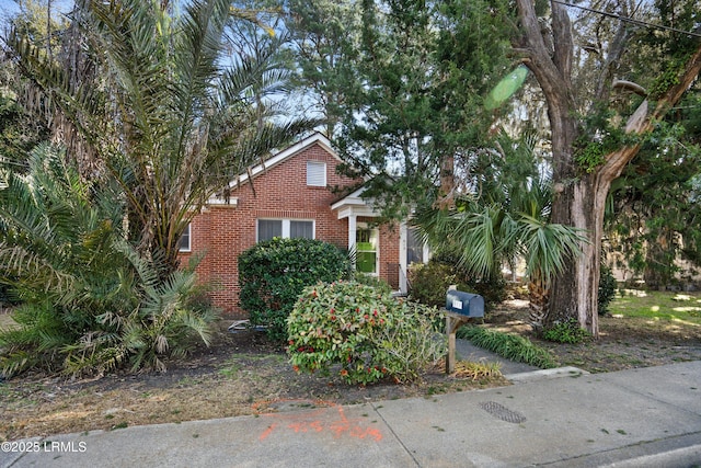 obstructed view of property featuring brick siding