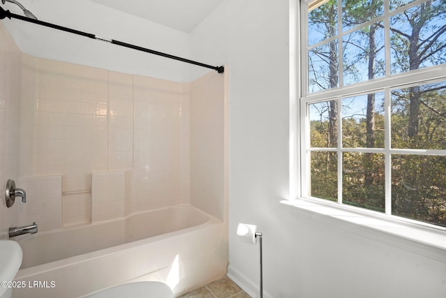 full bath with bathing tub / shower combination, toilet, and tile patterned floors