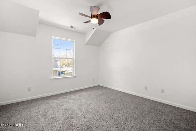 carpeted empty room with visible vents, baseboards, and a ceiling fan