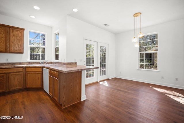 kitchen featuring dark wood-style floors, brown cabinets, and dishwasher