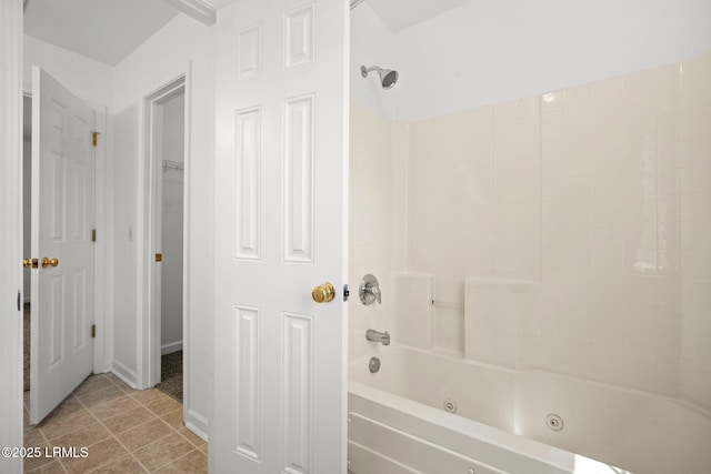 bathroom featuring tile patterned floors, a closet, and a combined bath / shower with jetted tub