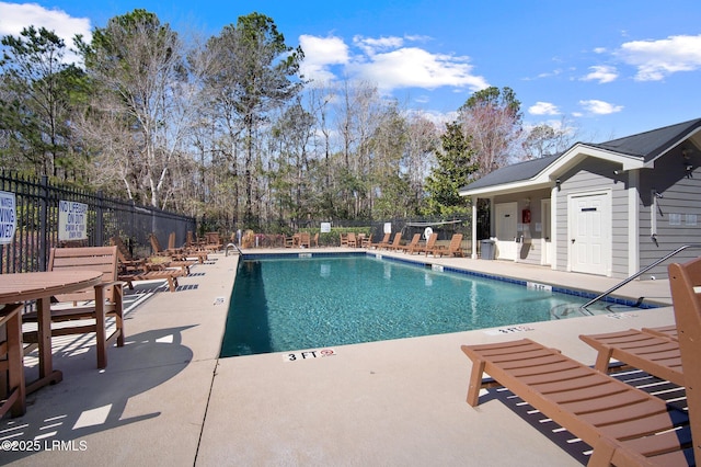 pool featuring a patio area and fence