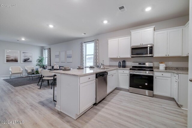 1530 Sanctum St, Ridgeland, SC 29936 - kitchen featuring stainless steel appliances, a sink, open floor plan, a peninsula, and white cabinetry
