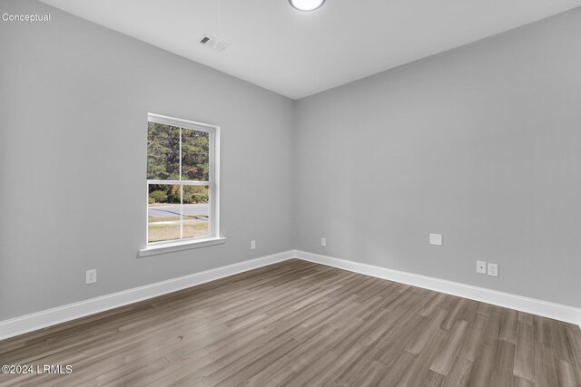 spare room featuring hardwood / wood-style floors