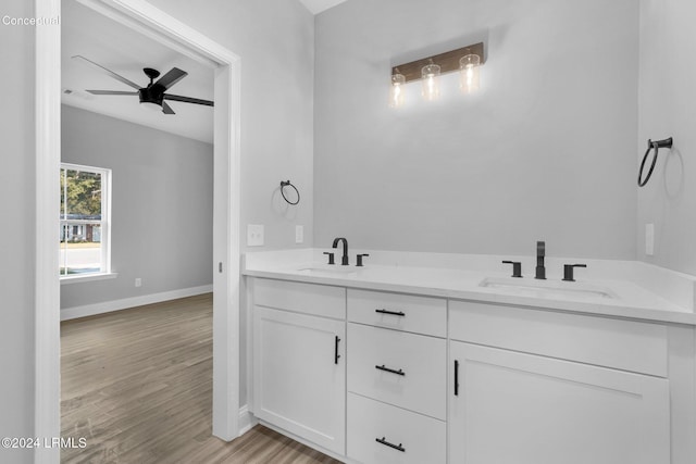 bathroom with hardwood / wood-style flooring, ceiling fan, and vanity