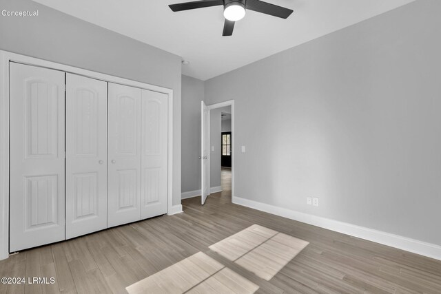 unfurnished bedroom with ceiling fan, light hardwood / wood-style floors, and a closet