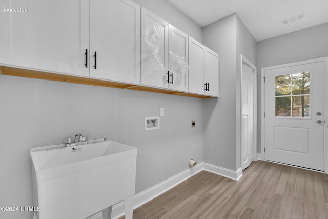 laundry room with sink, cabinets, washer hookup, electric dryer hookup, and light wood-type flooring