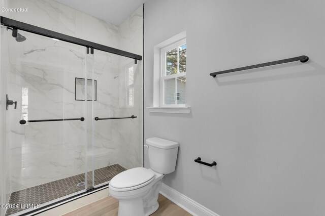 bathroom with hardwood / wood-style flooring, toilet, and an enclosed shower