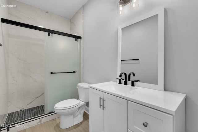 bathroom with vanity, wood-type flooring, a shower with door, and toilet