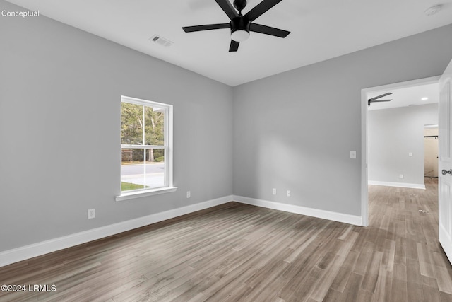 spare room featuring light hardwood / wood-style floors and ceiling fan