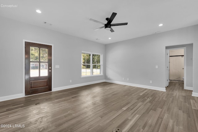 interior space with hardwood / wood-style floors and ceiling fan