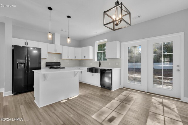 kitchen with decorative backsplash, a kitchen island, white cabinets, and black appliances