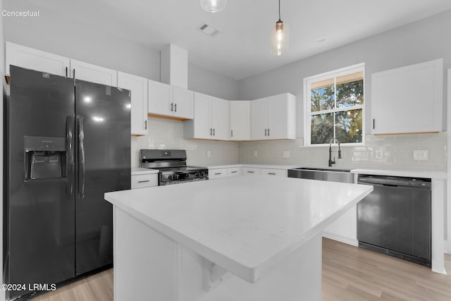 kitchen featuring white cabinetry, a kitchen island, pendant lighting, and black appliances