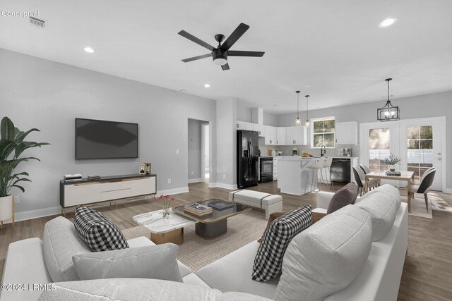 living room with ceiling fan and wood-type flooring