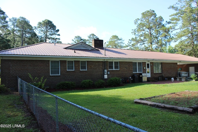 110 Joey St, Hampton, SC 29924 - rear view of property with brick siding, a chimney, metal roof, and a patio